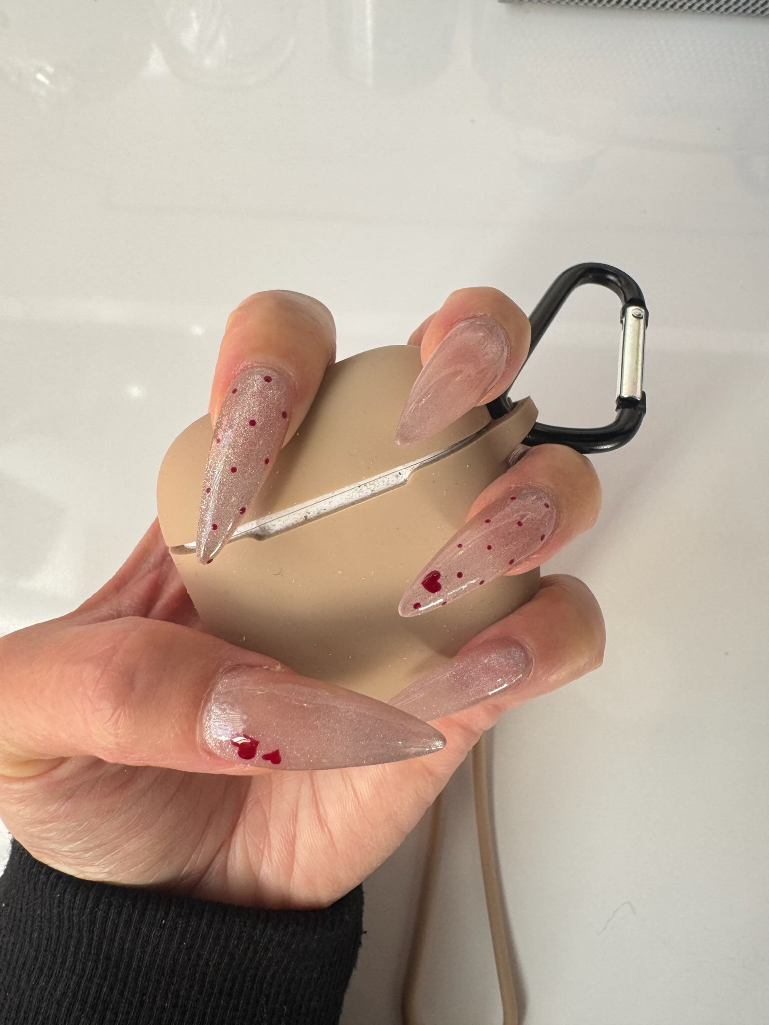Chrome accent nails catching the salon light